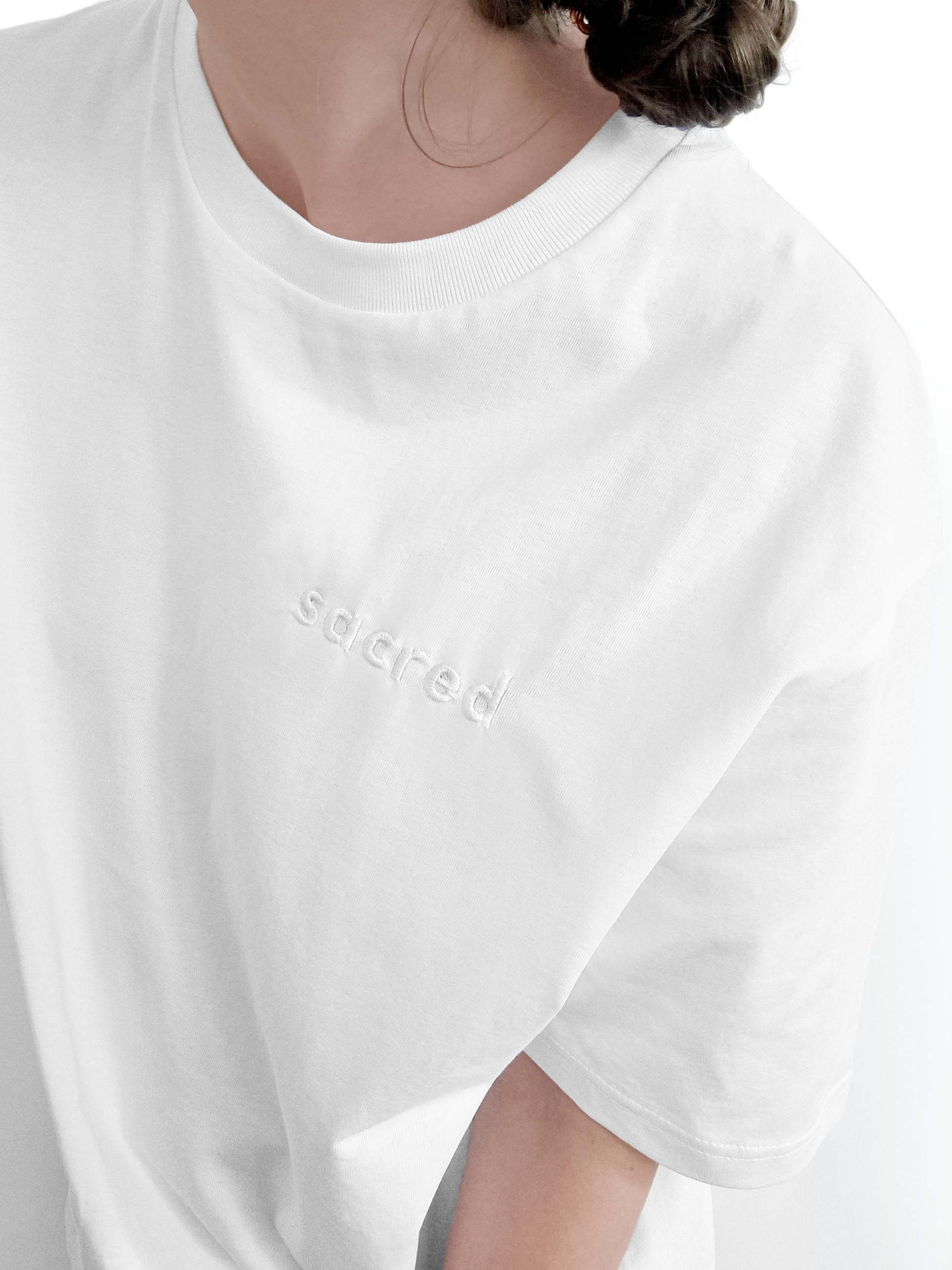 Ethical and sustainable, white organic cotton tee / t shirt with embroidered sacred design for yoga, gym, or lounge wear.